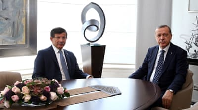 Turkish President Recep Tayyip Erdogan (R) receives Turkey's Prime Minister Ahmet Davutoglu, [Getty]