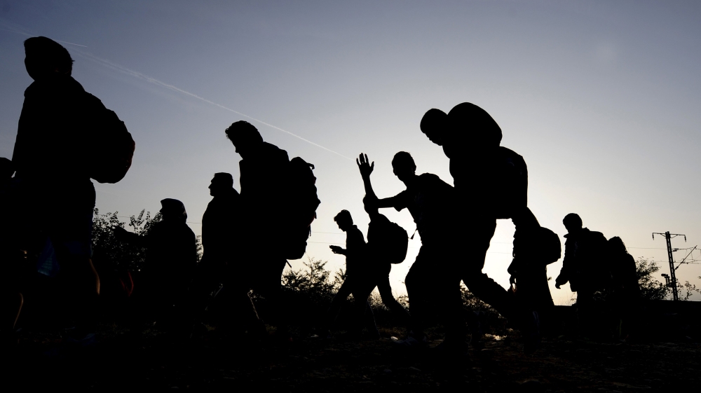 Migrants wait to enter a transit camp in Gevgelija, Macedonia, after entering the country by crossing the border with Greece [REUTERS]