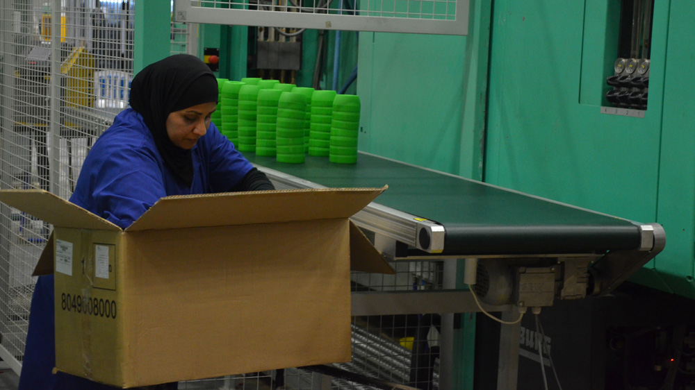 Thirty-seven Palestinians travel up to four hours each day to work in the new SodaStream factory, built on the ruins of a Bedouin village [Kate Shuttleworth/Al Jazeera]