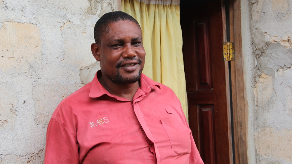 His home may not be quite complete, but John Gbara says he is a happy man [Femke van Zeijl/Al Jazeera]