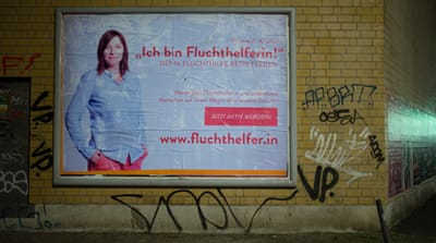 The fluchthelfer promotional poster reads: 'Now become a fluchthelfer and help people have a better future' [Peng Collective]