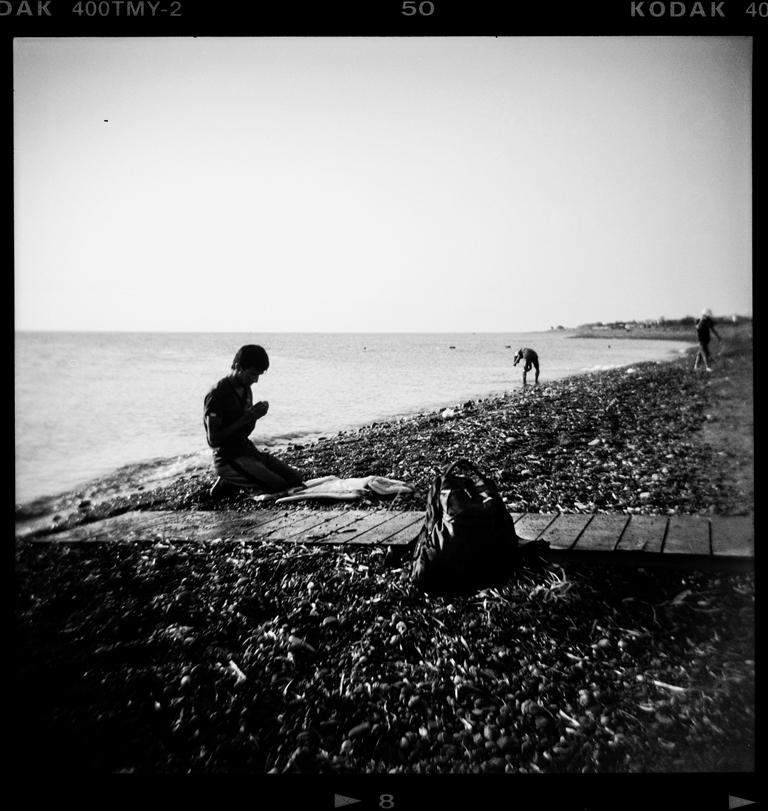 A refugee prays moments after he arrived in a dinghy on Psalidi beach on the Greek island of Kos – Kos, Greece, August 2015 [Giorgos Moutafis] 
