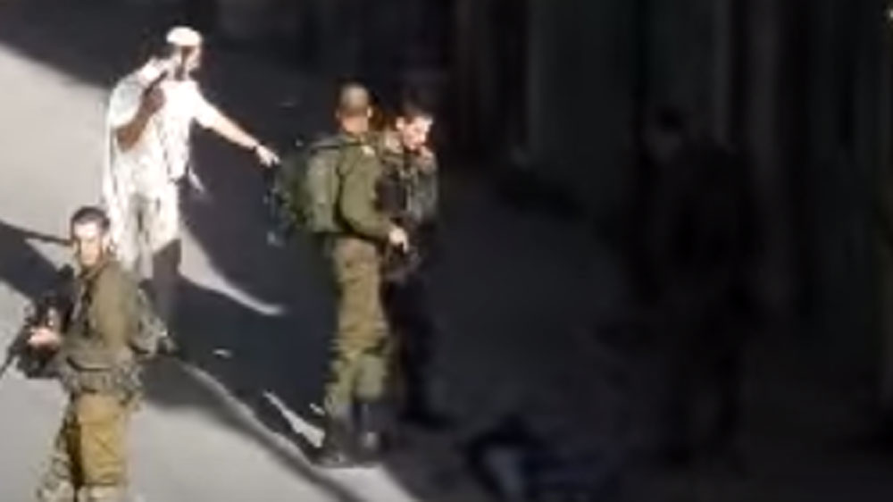 Video footage captured the moment after a settler shot dead a Palestinian in Hebron following an alleged stabbing attempt [Screen grab/YouTube]