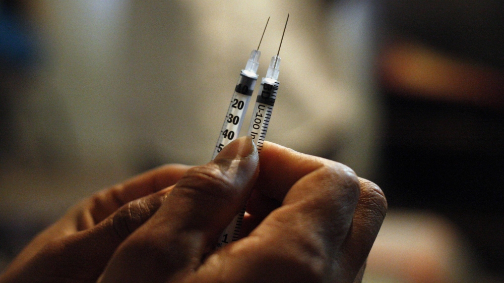 Rojas, coordinator of the Harm Reduction for Injecting Drug Users, shows the needles used by drug addicts users at a drug den in Ciudad Juarez