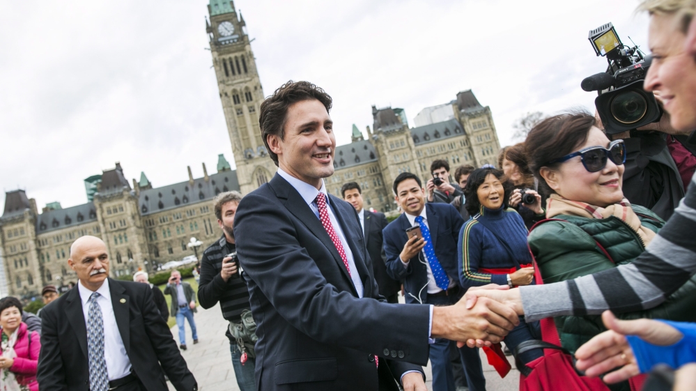 Canadian Prime Minister designate Justin Trudeau greets people as he leaves Parliament Hill for a press conference in Ottawa, Canada [EPA]