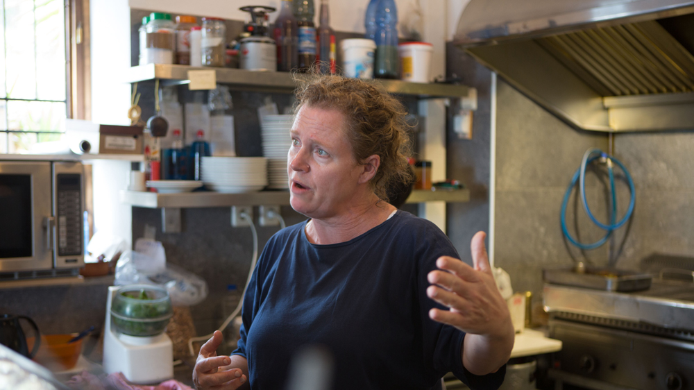 At first, McRostie would help refugees on her own. But international attention soon brought volunteers to the island who were eager to help. [Andrea DiCenzo/Al Jazeera]