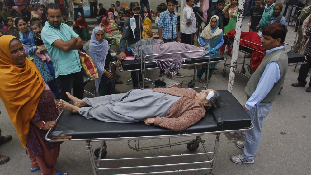 Patients who were shifted outdoors at the government medical college hospital after a strong tremor was felt in Jammu, India [Channi Anand/The Associated Press]