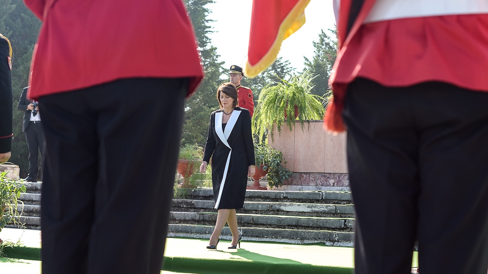 President Jahjaga walks alone during a wreath laying ceremony at the Mother Albania monument, located at the National Martyrs Cemetery of Albania [Valerie Plesch/Al Jazeera]