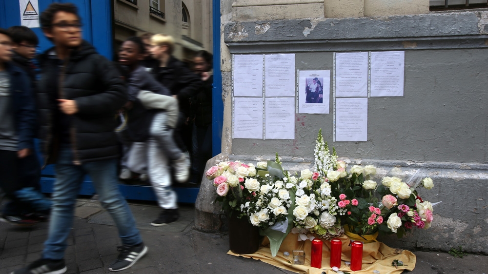 Messages from students are posted on the walls of the Victor Hugo Junior High School, above flowers and candles in memory of Kheireddine 