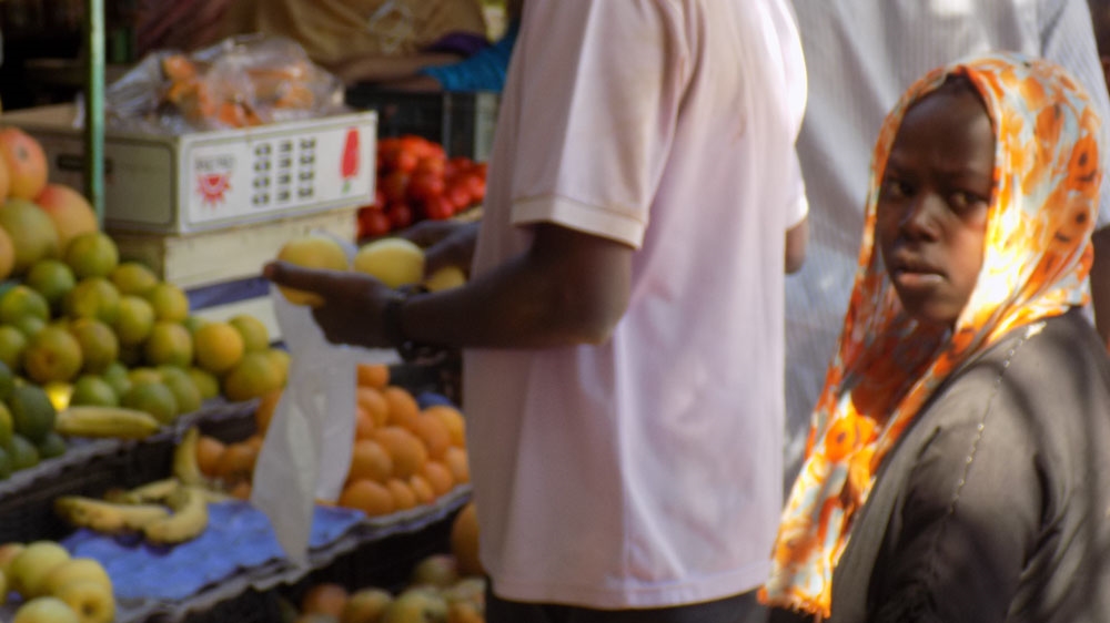 Omniya lives near a market and dreams of tasting all the fruits she cannot afford to buy [Ahmed Saeed/Al Jazeera]