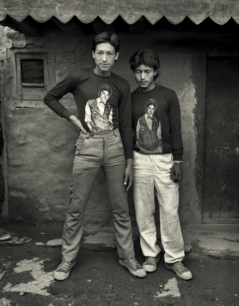 Newar Cousins, Jumla Bazaar, Jumla, 1985. The first cousins are sons of Newar merchants in Jumla Bazaar, the government administrative seat for the Karnali Zone. Their families have lived for the past full generation in Jumla and travel at least once a year by airline to Kathmandu. From 'Portraits of Nepal' [Kevin Bubriski]
