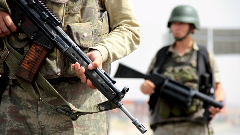 Turkish soldiers stand guard at a check point on the main road between Mardin and Cizre near the southeastern town of Midyat, Turkey