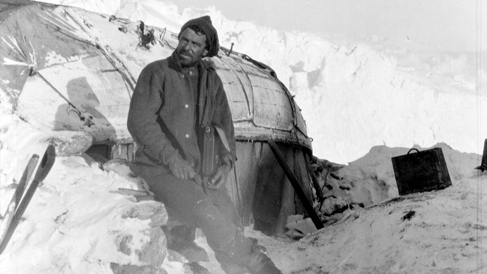 Hurley is seen here outside a makeshift hut that had become home. Courtesy: RGS-IBG