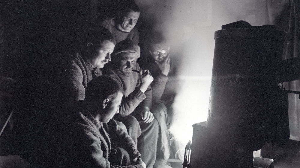 The men onboard Endurance before the ship sank in the Weddell Sea. A sixth man can just be seen behind the man with the glasses. Courtesy: RGS-IBG
