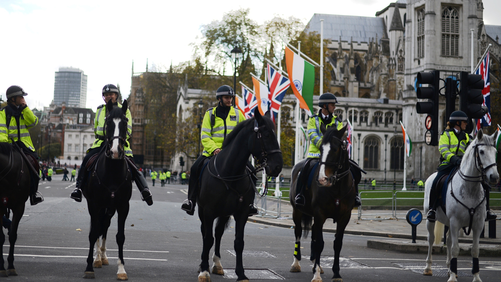 Police guard Downing Street as Modi and Cameron meet inside and two groups of demonstrators gather outside [Lydia Noon/Al Jazeera]