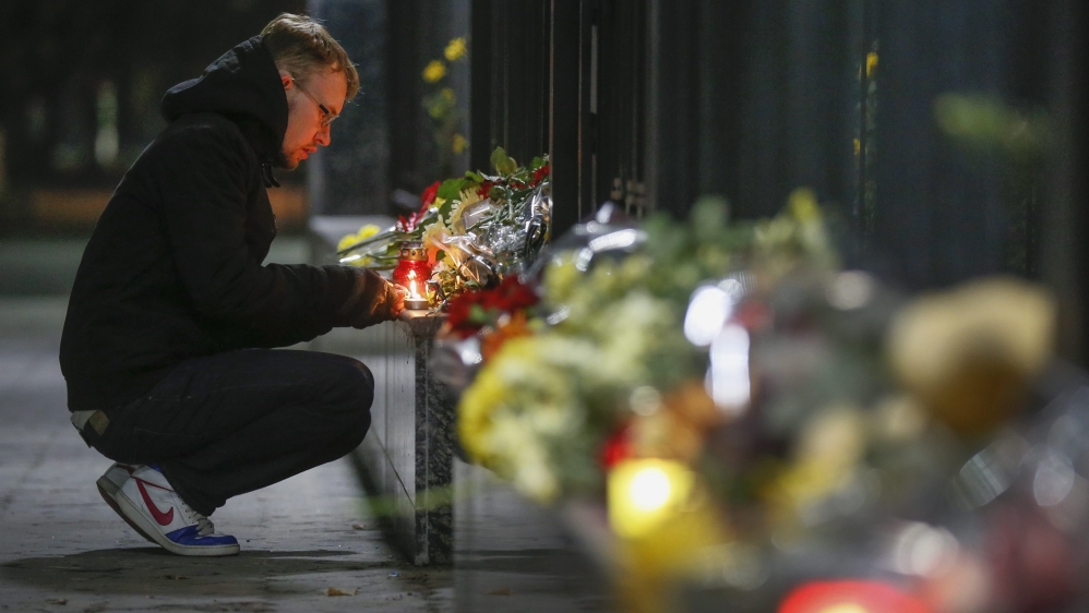  Ukrainians lay flowers and light candles in memory of victims at the Russian embassy in Kiev, Ukraine [Sergey Dolzhenko/EPA] 