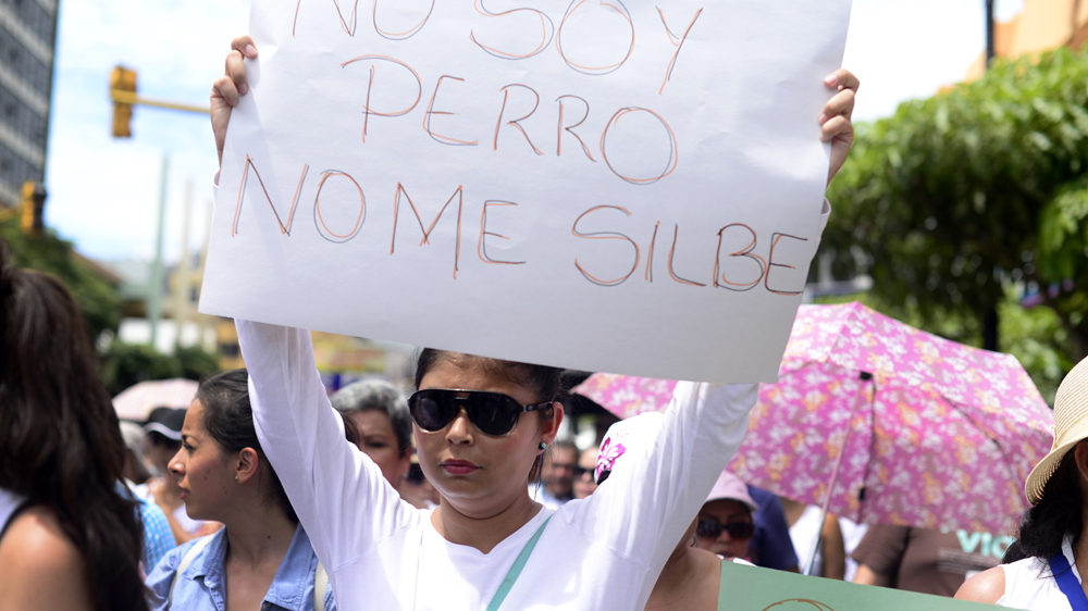 'I am not a dog, do not whistle at me' reads a sign during an anti-sexual harassment demonstration in Costa Rica [Lindsay Fendt/Al Jazeera]