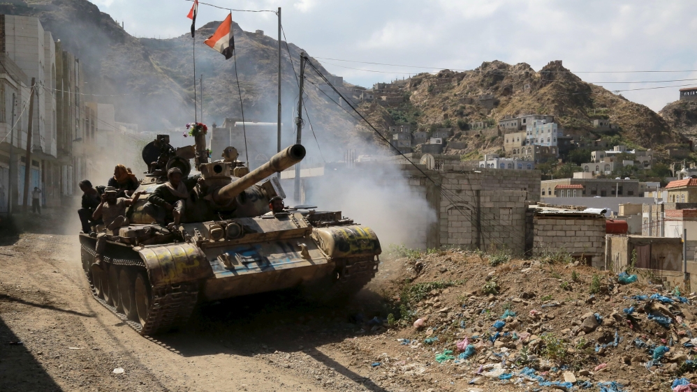 Soldiers loyal to Yemen''s government ride atop a tank in the country''s southwestern city of Taiz