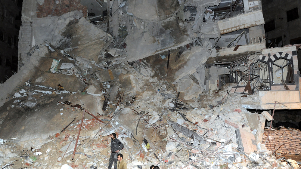 
The residential building in the south of Jaramana on the outskirts of Damascus collapsed after the strike [SANA/EPA]
