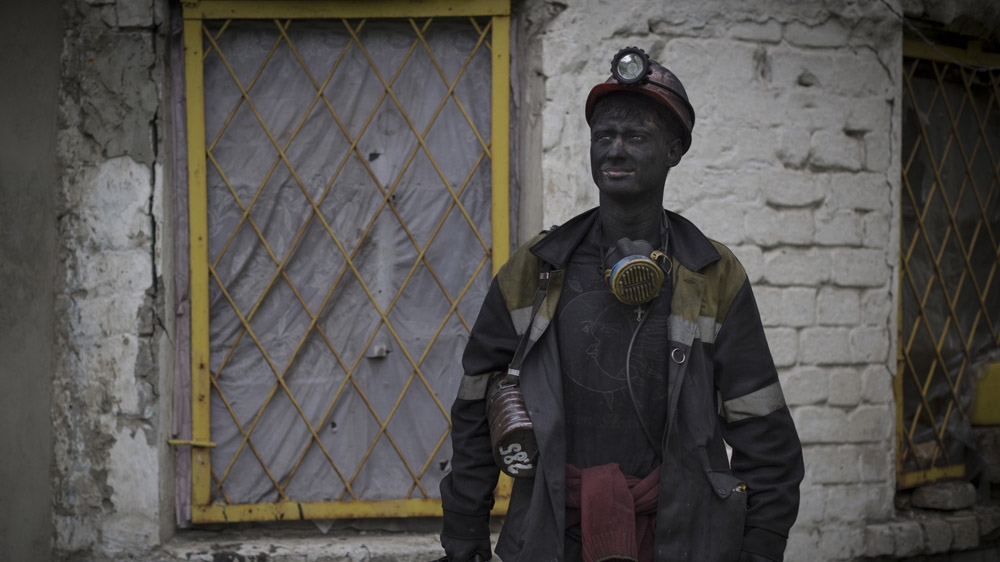 Twenty-year-old Vasily was reluctant to let a stranger photograph him. Then one night, after a few beers, he eventually agreed. He was surprised when we turned up at the legal mine where he works in Viktoria, near Shakhtiorsk, the next day. But, as one of his friends explained to us, among Russian men, 'if you say, you must do - otherwise you're not a real man'. [Janos Chiala and Tali Mayer/Al Jazeera] 