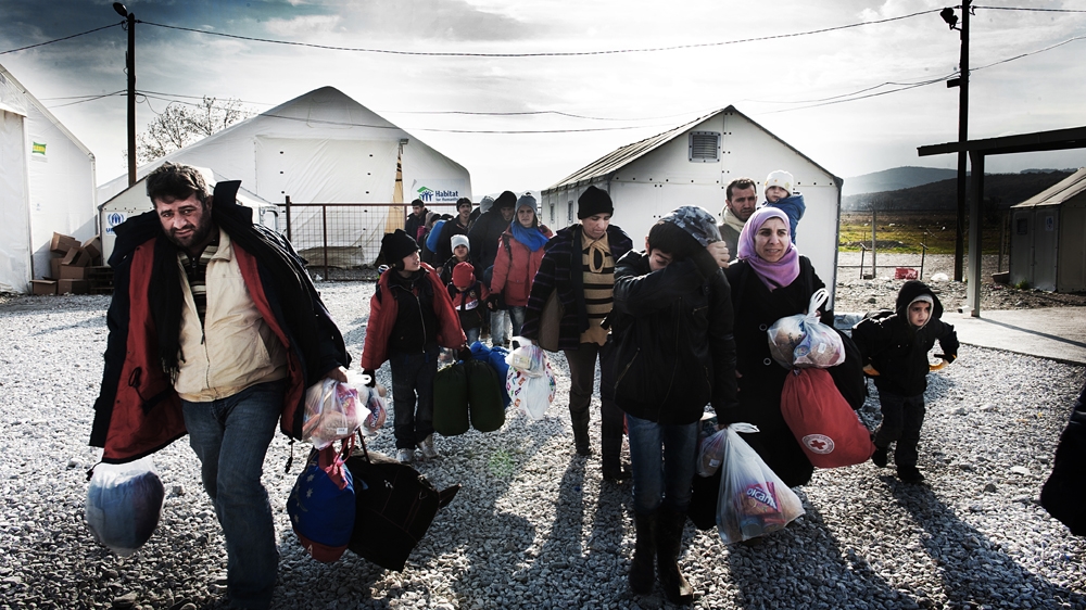 Mothers, fathers and children carry all they can [Mona van den Berg/Al Jazeera]