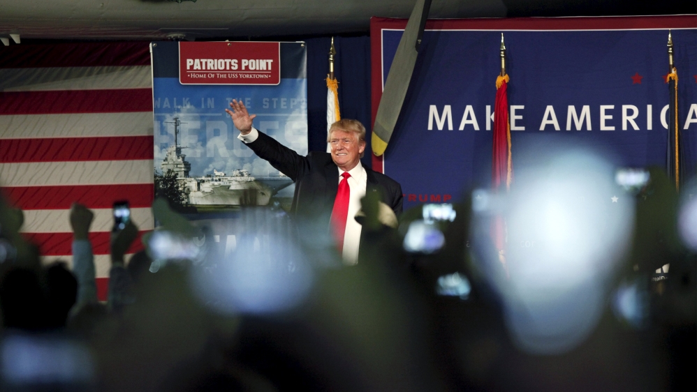 U.S. Republican presidential candidate Donald Trump waves to the crowd at a Pearl Harbor Day rally aboard the USS Yorktown Memorial in Mount Pleasant