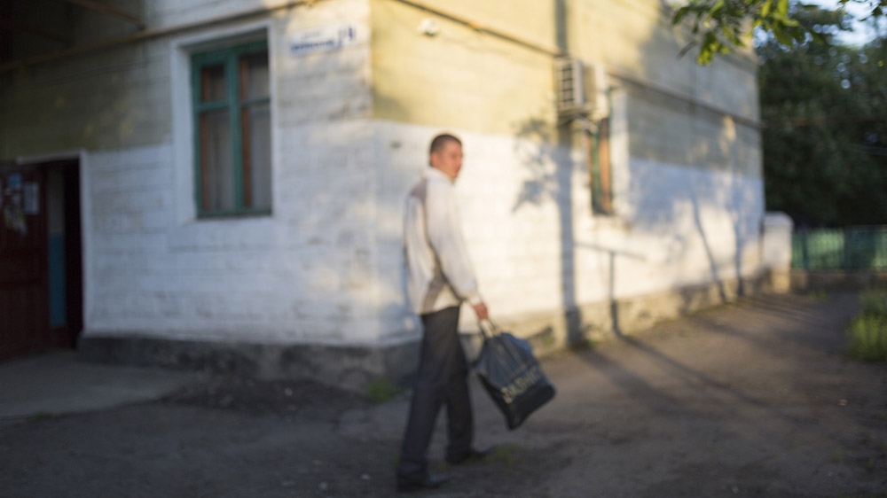 Twenty-nine-year-old Ivan is going to work in Shakhtiorsk at 5:30am, after drinking a couple of beers. He is married and became a father for the first time a few weeks ago. He often jokes about how every day, when he goes to work, he does not know if he will return alive. But when asked if he is afraid, he laughs and says: 'You don't ask this question to a Russian.' [Janos Chiala and Tali Mayer/Al Jazeera] 