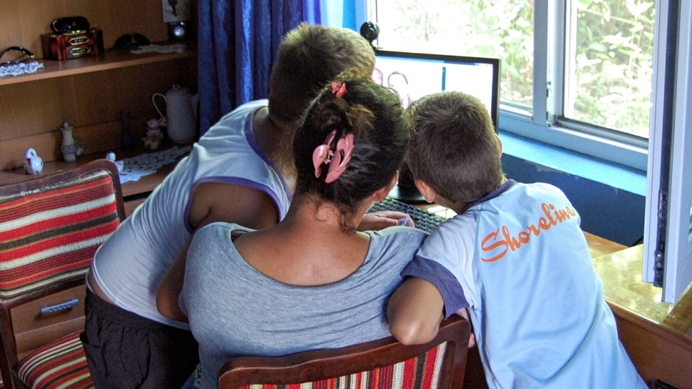 Jocelyn's biological brothers, 10-year-old Mihai and eight-year-old Tomian were excited to learn that they had an American sister [Lina Vdovii/Al Jazeera]