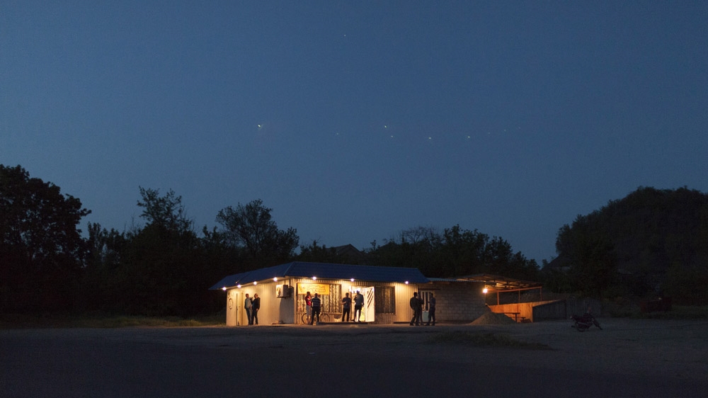 This is the only shop in the mining community of Davidovka and in the evenings it doubles up as the area's only bar. [Janos Chiala and Tali Mayer/Al Jazeera] 