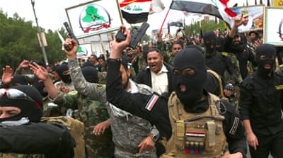 Shia militiamen and protesters shouted slogans and brandished weapons during the demonstration [AP]