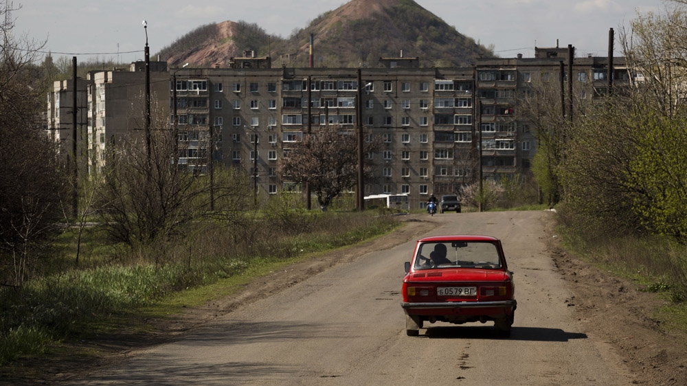 Krasnodon is a mining town some 5km from the Russian border. In the background is the defining feature of the Donbass landscape: the terrikon, a mound of debris excavated by a mine. [Janos Chiala and Tali Mayer/Al Jazeera] 