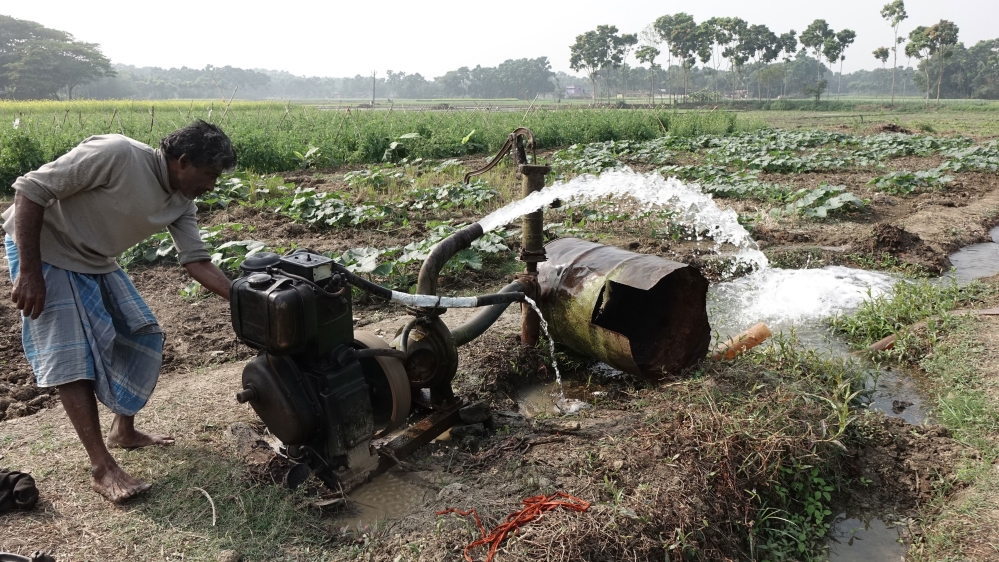 A farmer waters his crops using groundwater at Teghoria village. Scientists have long warned that deadly arsenic is entering the food chain because of the rampant use of arsenic-rich groundwater in irrigation [Shaikh Azizur Rahman/Al Jazeera]