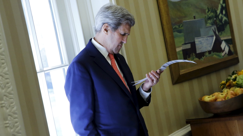 U.S. Secretary Kerry looks at his notes as he attends a meeting between Obama and Turnbull in the Oval Office at the White House in Washington
