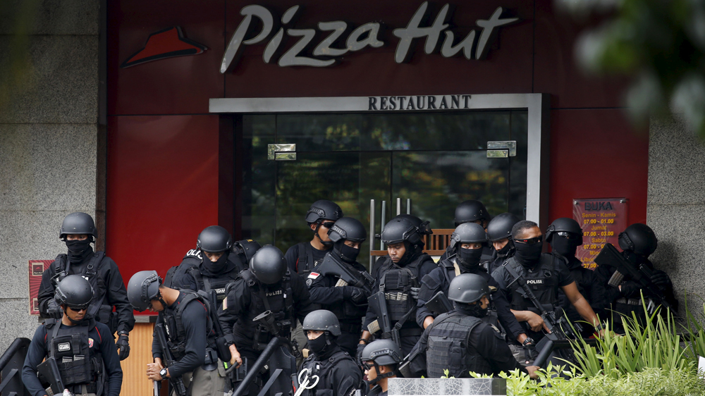 Police gathered outside a restaurant near the scene of an attack in central Jakarta [Beawiharta/Reuters]