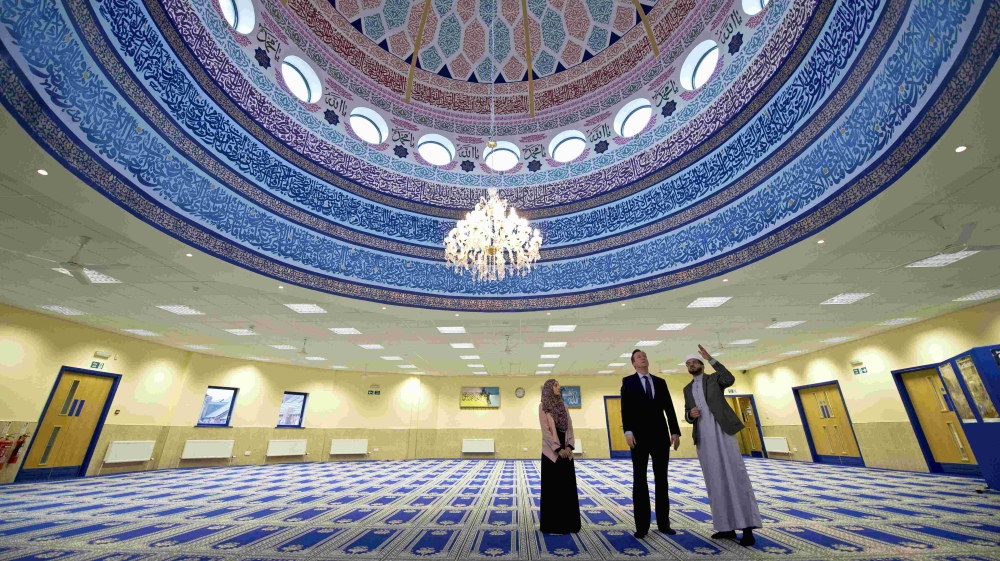 Britain''s Prime Minister David Cameron speaks with imam Qari Asim and Shabana Muneer as he visits the Makkah Masjid Mosque in Leeds