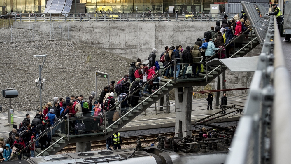 Police organize the line of refugees at on the stairway leading up from the trains arriving from Denmark at the Hyllie train station outside Malmo