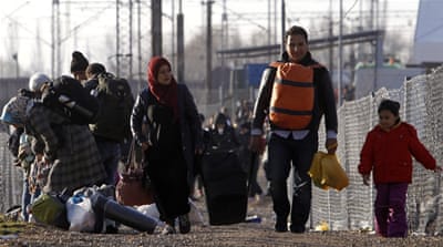 Refugees walk towards the border with Serbia [AP]