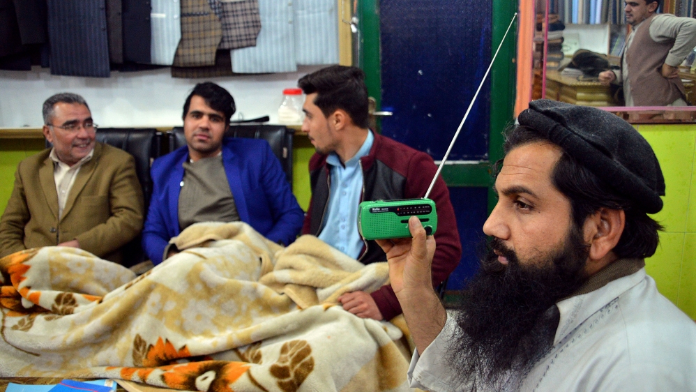 An Afghan shopkeeper listens to Islamic State Radio at his shop in Jalalabad, capital of Nangarhar province [AP]