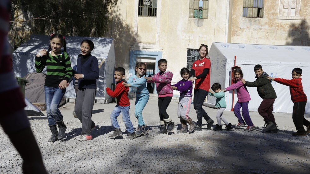International volunteer groups take turns cooking lunch and caring for the refugees [AP]