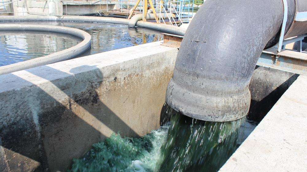 
Blue coloured dye from various factories flows into the oxidation chamber of the effluent treatment plant where bacteria consume the dye [Sandhya Ravishankar/Al Jazeera]
