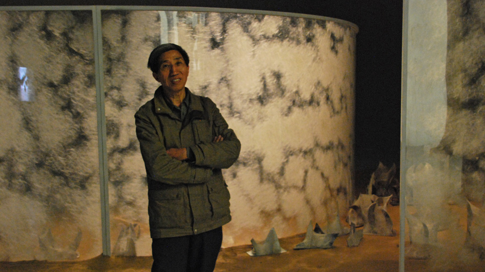 Artist Liang Shaoji utilised 30,000 silkworms over three years to create his work [Anna Nigmatulina/Al Jazeera]