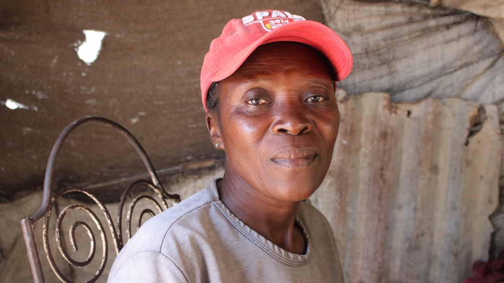 Mercilus Pierre Louis, a mother of three, lived in a small tent when she first came to Canaan. Now she owns a house and runs a charcoal-selling business [Stephanie Ott/Al Jazeera] 