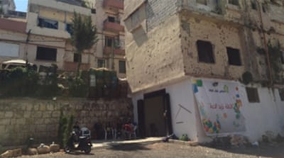 Just a few months ago, the building that now houses the cafe was pockmarked with bullet holes with all the window glass blown out [Photo courtesy of Lea Baroudi]