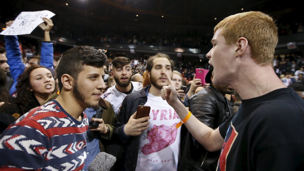 A Trump supporter yells at demonstrators after Republican U.S. presidential candidate Donald Trump cancelled his rally at the University of Illinois at Chicago