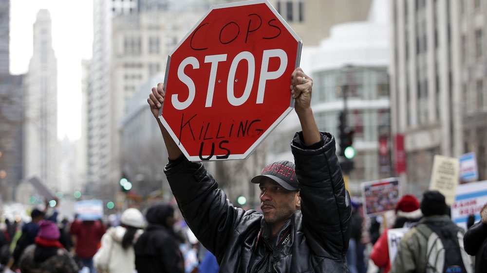 A demonstrator protests against the shooting of 17-year-old Laquan McDonald by Chicago police officer Jason Van Dyke [Joshua Lott/Getty Images]