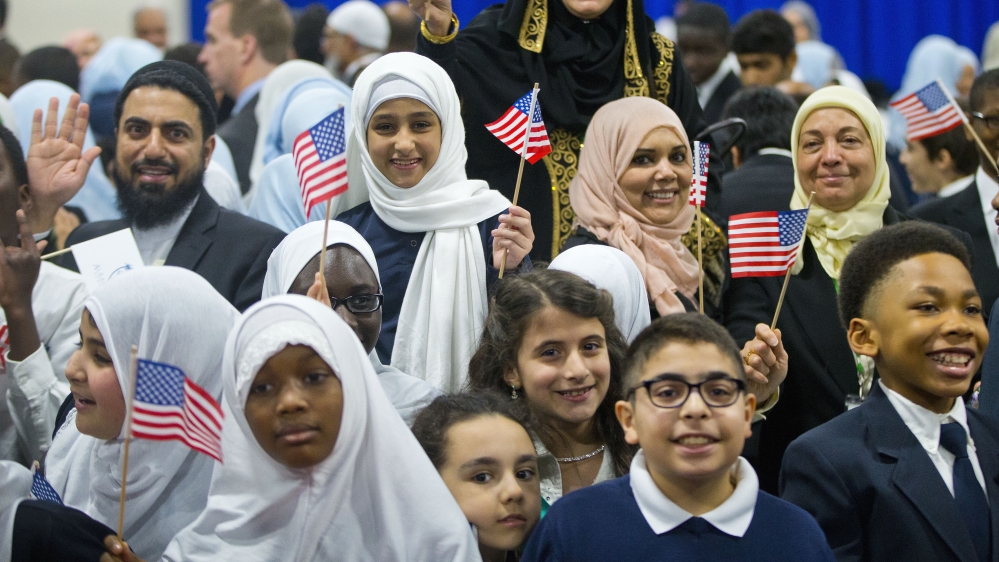 Children from Al-Rahmah school and other guests react after seeing President Barack Obama during his visit to the Islamic Society of Baltimore [AP]