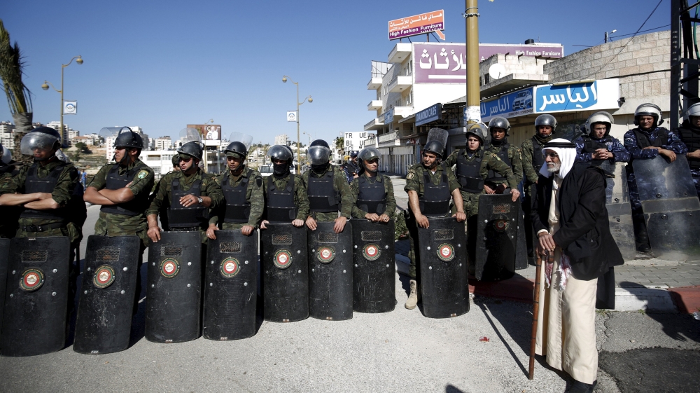 Members of Palestinian security forces stand guard during a rally in support of Palestinian journalist Mohammad al-Qiq,in the West Bank city Ramallah