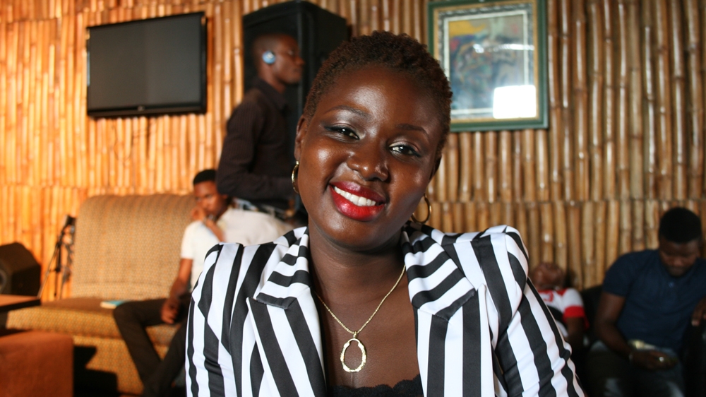 A female contestant waits as the stage is set up for the 2015 War Of Words poetry slam in Lagos [Caelainn Hogan/Al Jazeera] 