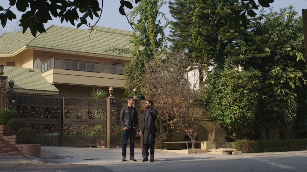 Dr Ghairat Baheer with Fault Lines correspondent Sebastian Walker outside Baheer's home in Islamabad where he was arrested in 2002 [Singeli Agnew / Al Jazeera]