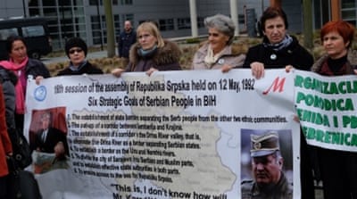 Demonstrators gather outside the ICTY before the trial of Radovan Karadzic, in The Hague, Netherlands [AP]